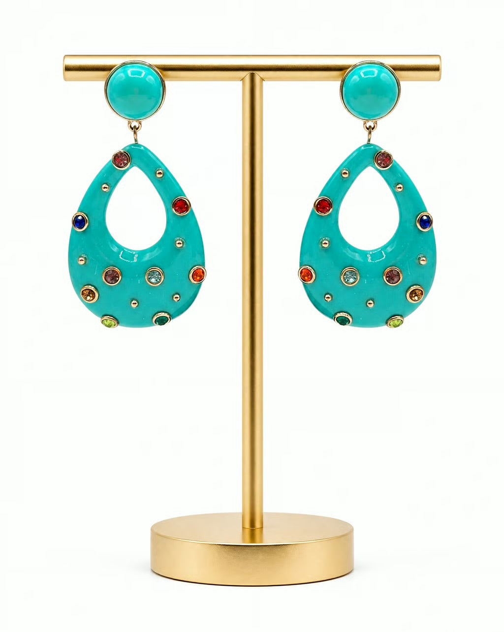 A pair of turquoise teardrop dangle earrings with multicolor rhinestone embellishments, displayed on a gold T-bar stand against a white background.